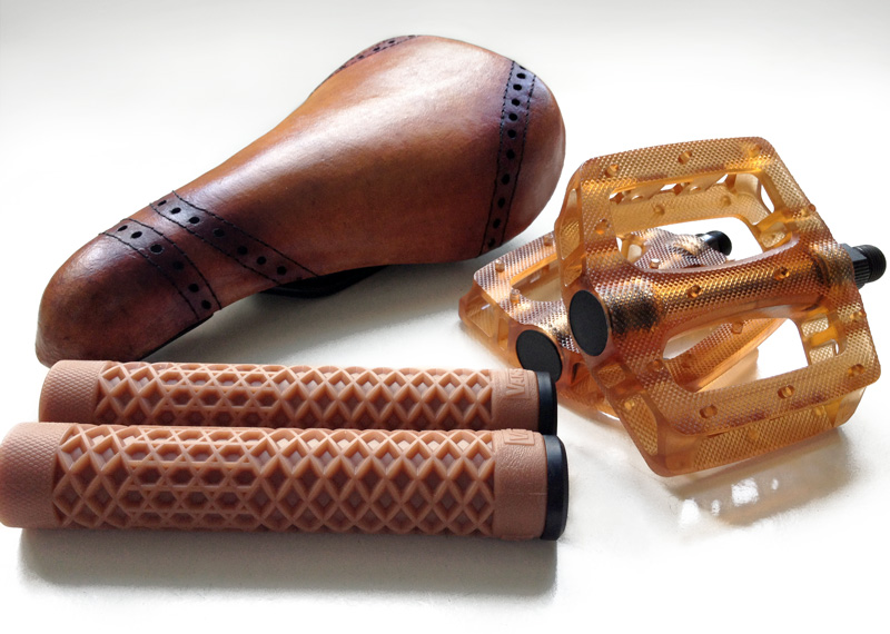 Brown BMX parts in leather, rubber and polycarbonate